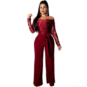 Detail of burgundy off-shoulder jumpsuit with lace floral embroidery and waist tie bow