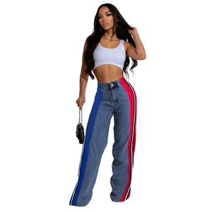 Detail of high waist straight jeans with side color block striped panels and denim texture