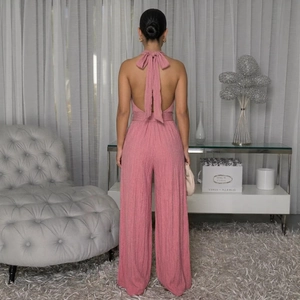 Elegant backless sleeveless pink jumpsuit with wide leg and neck tie bow detail
