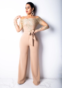 Detailed embroidery on mesh sleeves and off-shoulder neckline of beige wide-leg jumpsuit