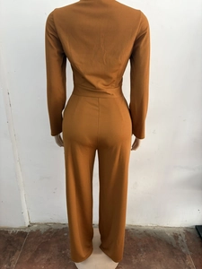 Detail of the high-waisted ribbed fabric back on this mustard wide-leg jumpsuit
