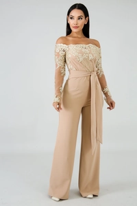 Detail of elegant off-shoulder jumpsuit with sheer mesh and gold lace embroidery