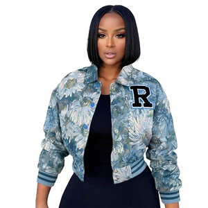 Detail of blue floral jacquard bomber jacket featuring embroidered R patch and rib trim