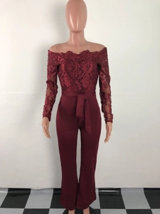 Detail of burgundy off-shoulder lace jumpsuit with floral embroidery and wide waistband