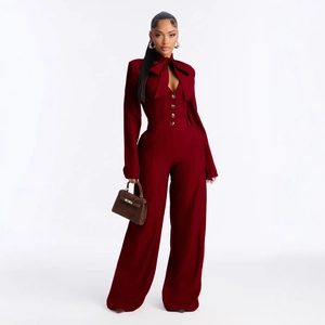 Elegant burgundy wide-leg jumpsuit with long sleeves and large bow neck detail