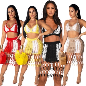 Detail of crochet beach set showing boho knit halter top and tasseled skirt in vibrant colors