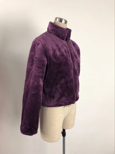 Détail de la texture en fausse fourrure pelucheuse d'une veste violette à col montant