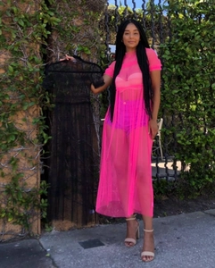 Detail of sheer mesh maxi top in neon pink and classic black with ruffle edges