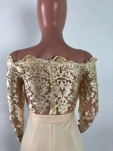Detail of champagne lace jumpsuit featuring off-shoulder design and back zipper closure