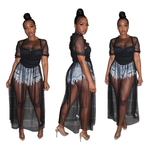 Detailed view of women's sheer mesh top with ruffled edges and denim shorts ensemble