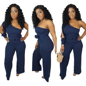 Detail of navy blue one-shoulder jumpsuit with long sleeve and tie waist belt decoration