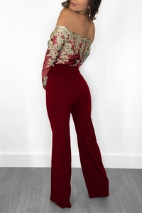 Detail of wine red off-shoulder jumpsuit with gold lace embroidery and wide legs