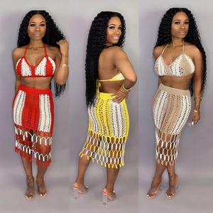 Detail of handmade crochet knit bikini top and fringe skirt set in various colors