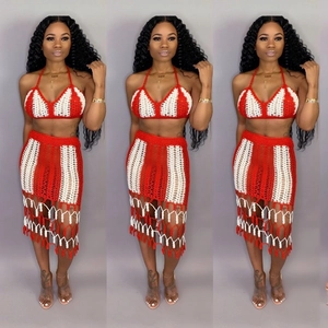 Detail of red and white striped crochet knit bikini set with high-waisted fringe skirt