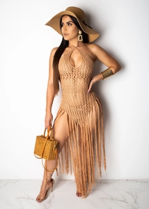 Detail of bohemian khaki crochet beach dress featuring long fringes and knit texture