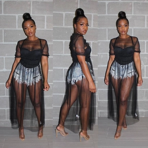 Three-way view of a black sheer mesh top and long skirt set with ruffle trim details