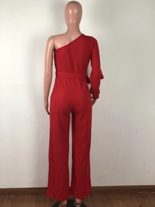 Rear view of red one-shoulder jumpsuit featuring long sleeve and tie waist detail