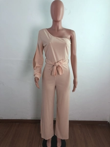 Detail of nude pink one-shoulder jumpsuit with waist tie and wide-leg trousers design