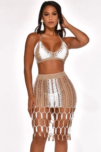 Detailed macro view of beige and white crochet knit pattern on bohemian beach skirt