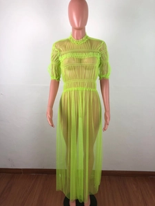Detail of neon green mesh long dress featuring ruffled high neck and ruched texture details