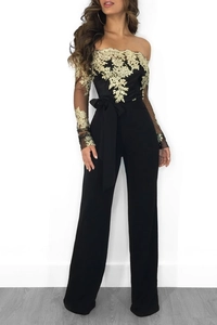Detail of gold floral embroidery on black mesh sleeves and off-shoulder lace jumpsuit