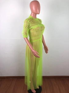 Detailed side view of neon green sheer mesh long dress with ruffle trim and pleats