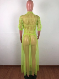 Detail view of the back of a neon yellow sheer mesh maxi dress with vertical textures