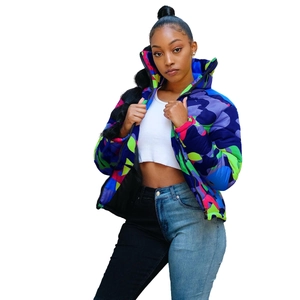 Detail of colorful camo puffer jacket featuring vibrant purple and neon green street style print