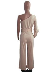 Detail view of the back of a beige one-shoulder jumpsuit with wide legs and fabric belt