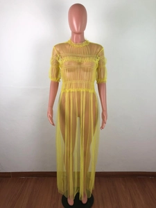 Detail of sheer yellow mesh dress showing ruffled collar and tiered ruched texture