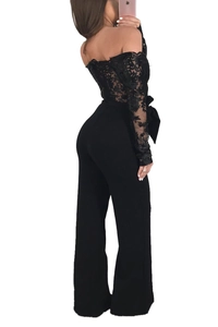 Detail of elegant black off-shoulder lace jumpsuit with floral embroidery and waist ribbon