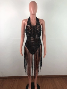 Detail of black crochet halter beach dress featuring long bohemian fringe tassels