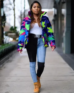 Detail of colorful camo puffer jacket and patchwork denim jeans for street style fashion