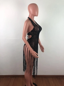 Detail of black crochet halter beach dress featuring long tassels and side cutouts