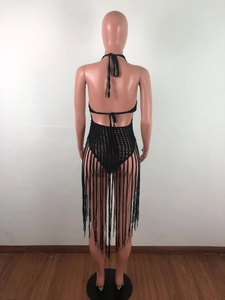 Detail of black crochet beach dress featuring open back ties and long bohemian tassels