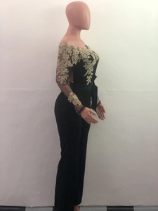 Detail of gold lace embroidery on black off-the-shoulder long sleeve jumpsuit for women
