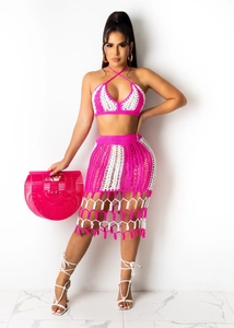 Detail view of pink and white crochet two-piece beach set with fringe and mesh pattern