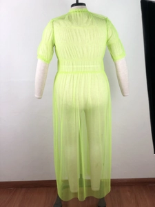 Detail of neon lime mesh dress showing sheer fabric texture and ruched waistline
