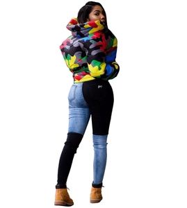 Close-up of unisex hooded jacket with colorful camouflage pattern and patchwork denim jeans