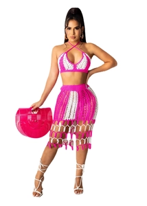 Detail of crochet two-piece beach set featuring pink stripes and tassel hemline