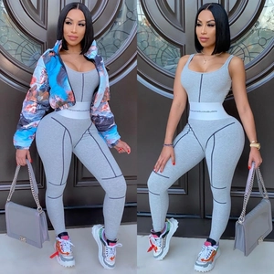Women's blue oil painting puffer jacket with grey ribbed bodysuit and white slogan belt
