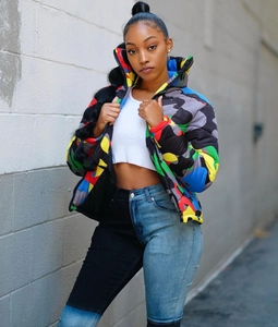 Detailed street style shot of colorful camo puffer jacket with high collar and black zipper