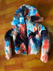 Close-up of winter puffer jacket featuring abstract oil painting print and hood detail