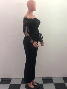 Detail of off-shoulder lace neckline and sheer crochet long sleeves on black jumpsuit