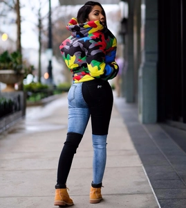 Detailed view of colorful camouflage puffer jacket with hooded design and thick padding