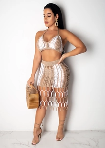 Detail of crochet knit texture and tassel hem on the two-piece beach skirt set