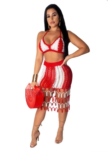 Detail of red and white crochet two-piece beach set with tassel hem and knit texture