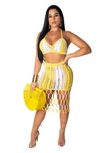 Detailed macro shot of yellow and white hand-crochet knit beach set with fringe tassel