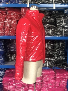 Détail d'une doudoune en cuir PU brillant rouge avec col montant sur un mannequin
