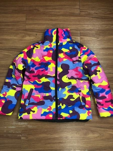 Detailed close-up of vibrant colorful camouflage pattern on unisex padded puffer jacket